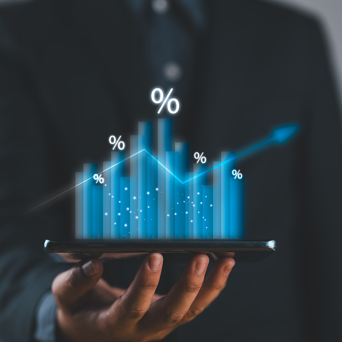 Person holding tablet with rising graph.